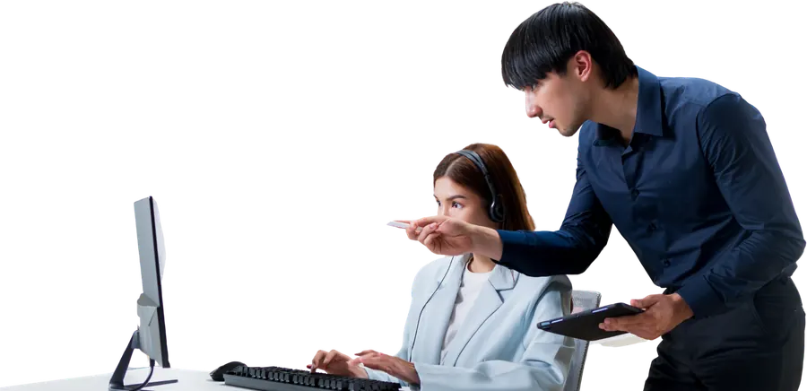 A specialist helping a colleague at their workstation